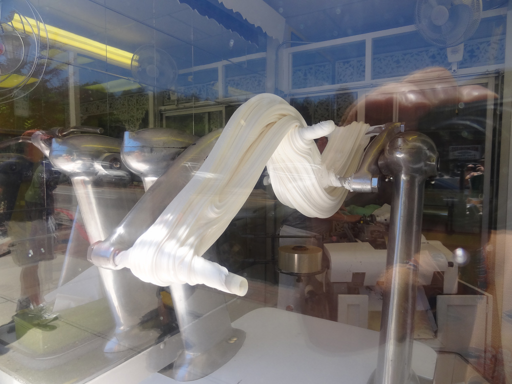 white taffy being stretched on a taffy pulling machine